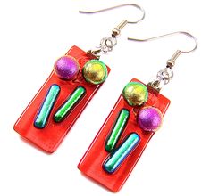 pair of colorful earrings on red background