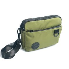 An earthy olive green with a silver gray liner. Versatile, fun and cute this lightweight bag features 3 functions in 1. Wear it as a hip pack, crossbody bag or wristlet. Stay hands free and carefree with plenty of room for your wallet, keys, phone and other small everyday necessities. Our strap system is intended to create versatility of use and fit a variety of body types. Includes:-4 zippered compartments -52” strap that fits waist/hip size 39”-61.5” or extend fully for crossbody wear -31” str Casual Green Phone Bag For Everyday, Functional Green Belt Bag For On-the-go, Green Crossbody Phone Bag With Adjustable Strap, Green Casual Belt Bag With Adjustable Strap, Casual Green Belt Bag With Adjustable Strap, Green Zipper Pouch For On-the-go, Green Casual Crossbody Phone Bag, Casual Green Crossbody Phone Bag, Crossbody Belt Bag With Cell Phone Pocket For Outdoor