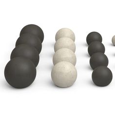 a row of black and white balls next to each other