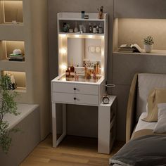 a white vanity with lights on it in a bedroom next to a bed and bathtub