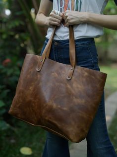 We use full grain vegetable tanned leather that gives the bag a vintage look and will develop a smooth patina with use.  No two bags are exactly the same as the leather color varies slightly.  You'll love the original look. Vintage Brown Satchel For Daily Use With Large Capacity, Vintage Brown Large Capacity Shoulder Bag For Daily Use, Everyday Vintage Brown Shoulder Bag With Large Capacity, Everyday Vintage Brown Large Capacity Shoulder Bag, Oiled Leather Shoulder Bag With Waxed Finish, Waxed Oiled Leather Shoulder Bag, Vintage Brown Double Handle Shoulder Bag For Daily Use, Vintage Brown Top Handle Shoulder Bag For Everyday Use, Everyday Vintage Brown Satchel With Leather Lining