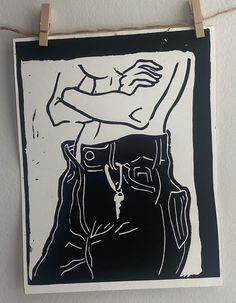 a black and white drawing hanging on a wall