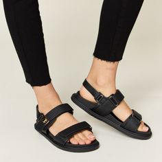 Step Up Your Summer Shoe Game With These Trendy Velcro Double Strap Slingback Sandals. The Double Strap Design With Velcro Closure Offers Both Style And Convenience, Making Them Easy To Adjust For The Perfect Fit. These Slingback Sandals Are Versatile And Perfect For Various Occasions, From Casual Outings To Summer Parties. The Supportive Yet Comfortable Design Ensures You Can Wear Them All Day Long Without Sacrificing Style. Elevate Your Warm-Weather Wardrobe With These Fashionable Velcro Doubl Black Synthetic Footbed Sandals With Adjustable Straps, Adjustable Strap Open Toe Jelly Sandals, Black Slingback Sandals With Strap For Spring, Black Adjustable Strappy Footbed Sandals, Black Strap Slingback Sandals For Spring, Spring Black Slingback Sandals With Strap, Black Strappy Footbed Sandals For Spring, Black Strappy Sport Sandals For Spring, Synthetic Jelly Sandals With Adjustable Strap And Round Toe