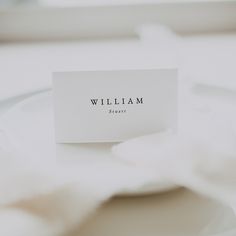 a place card sitting on top of a white plate