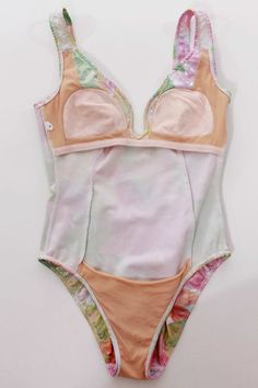 This incredible 1980-90s vintage swimsuit shines and sparkles like no other! You'll be thrilled when your package arrives as this looks so much better in person with all its light catching sparkle. Thick, stretchy, very well made fabric in pastel pink, green, orange, yellow and silvery white with colorful rainbow flecks throughout give it a near sequin-like appearance. Shape enhancing Princess seams with supportive boning along the v-shaped neckline. Very deep back, partial beige mesh lining, st Pink Stretch Bodysuit With Lined Body, Pink Summer Party Leotard, Pink Stretch Leotard For Summer, Summer Stretch Pink Leotard, Pink Sleeveless Nylon Bodysuit, Spring Pink Bodysuit With Built-in Bra, Fitted Pink Bodysuit With Lined Body, Fitted Pink Bodysuit With Built-in Bra, Pink Fitted One-piece Leotard