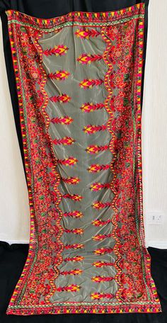 Phulkari hand-made multi-coloured thread Dupatta  shawl on a soft net material. Bordered edges and embroidery work all over the Dupatta.  Dupatta  shawl available in different colours. Perfect for Mehndi, weddings, party, and events. Great statement Dupatta/shawl for any outfit.  Please do not hesitate to contact us for any questions.  Please also visit our shop for more affordable Clothing and accessories. Affordable Multicolor Celebration Dupatta, Multicolor Jamawar Shawl With Embroidered Border, Red Pashmina Shawl With Resham Embroidery For Festivals, Multicolor Pashmina Shawl With Embroidered Border, Red Jamawar Shawl With Dupatta Detail, Red Jamawar Shawl Dupatta, Traditional Embroidered Green Shawl, Navratri Jamawar Dupatta With Resham Embroidery, Navratri Traditional Wear With Multicolor Embroidery And Sheer Dupatta