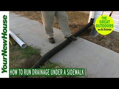 a man is using a hose to clean the sidewalk