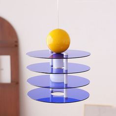 a yellow ball sitting on top of a glass table