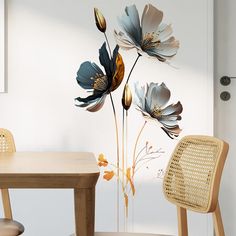 a dining room table and chairs with flowers painted on the wall