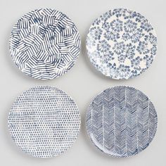 four blue and white plates sitting on top of each other