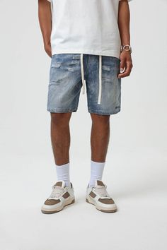 Bring an edgy touch to your casual wear with the Contrast Texture Ripped Denim Shorts. This pair is thoughtfully ripped throughout, adding a grungy twist to the classic washed blue color. With an elastic waistband design, which is highly unusual for denim shorts, you get the benefit of both style and comfort. The extended drawstrings allow for a customizable fit, adding to the unique appeal of these must-have shorts. Ripped throughout for a grungy aesthetic Classic washed blue color Elastic wais Casual Ripped Streetwear Bottoms, Ripped Washed Blue Bottoms For Streetwear, Urban Medium Wash Bottoms With Frayed Hem, Urban Style Medium Wash Bottoms With Frayed Hem, Casual Ripped Cotton Jean Shorts, Distressed Denim Blue Bottoms For Streetwear, Summer Streetwear Distressed Bottoms, Urban Style Ripped Medium Wash Bottoms, Urban Style Faded Bottoms With Frayed Hem