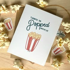 a greeting card with popcorn on the table