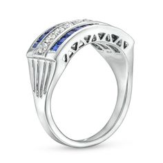 an 18k white gold ring with blue sapphires and diamonds on the sides, set in