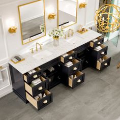 an aerial view of a bathroom vanity with marble top and gold accents on the mirror