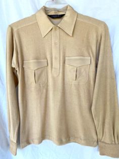 Up for sale is this great Vintage Men's Long Sleeve Polo shirt, made in the early 1980s by CAMPUS TERRY. It is in BRAND NEW OLD STOCK in PERFECT CONDITION.  Made of TERRY FABRIC (70% Polyester & 30% Cotton). Light Golden Brown in color. Men size Small.  Measurements:  Shoulder tip to shoulder tip= 18".  Armpit seam to armpit seam= 20".  Length from back collar seam to bottom of shirt= 26".  Sleeve length from shoulder tip to bottom of cuff= 24.5". Please feel free to message me with any questions. Light Golden Brown, Brown Shirt, Terry Fabric, Long Sleeve Polo Shirt, Long Sleeve Polo, Golden Brown, New Man, Vintage Men, Mens Long Sleeve