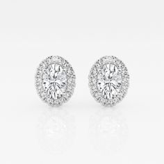 These imperial looking oval stud earrings are one of our best sellers. Large oval cut lab grown diamonds with a halo of round diamonds are a true amalgamation of style and glamor. Luxury Gia Certified Oval Diamond Earrings, Formal Gia Certified Oval Earrings, Elegant Gia Certified Oval Diamond Earrings, Luxury Oval Diamond Earrings With Halo Design, Dazzling Oval Brilliant Cut Diamond Earrings, Gia Certified Oval Diamond Earrings, Timeless Oval Halo Design Jewelry, Dazzling Oval Diamond Earrings With Prong Setting, Dazzling Oval Diamond Earrings For Anniversary