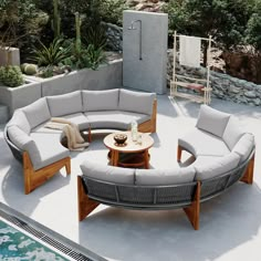 an outdoor living area with couches and tables next to a swimming pool in the background