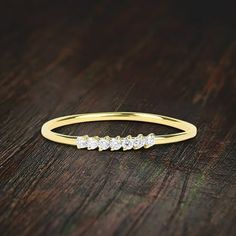 a yellow gold ring with five diamonds