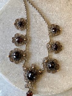 Beautiful Art Nouveau Austro Hungarian Garnet Filigree Sterling Silver Gold Ball Accent Vintage Antique Bib Festoon Necklace Measures aprox 16 inches around Antique Necklace With Historical Design For Formal Occasions, Antique Necklace With Historical Design For Formal Events, Victorian Pendant Necklace With Historical Design, Victorian Necklace With Historical Design For Formal Occasions, Victorian Historical Design Necklace For Formal Occasions, Victorian Historical Design Necklaces For Formal Occasions, Victorian Historical Design Formal Necklace, Victorian Round Necklace With Intricate Design, Victorian Necklace With Intricate Design