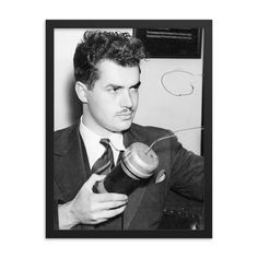 a black and white photo of a man holding an apple