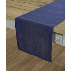 a blue table runner on top of a wooden table