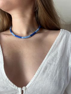 This blue, clay bead necklace is sure to elevate your look and add that touch of something-sea to your outfit!  Perfect worn just as is, or layered with some gold chains or a pearl necklace, this piece will look so good on a date to the beach, a fun night out with your besties, or as an everyday accessory! Although this necklace looks like it walked straight out of the ocean, I advise against getting it wet/spraying perfume on it, to prevent tarnish to the gold clasps!  Ships within 2-3 business days from date of purchase.  All profits from this shop will go towards the purchase of new camera gear and help me pursue my dream of being a full time wedding photographer, so returns/refunds will not be accepted at this time. Thank you for your understanding! Blue Necklace For Summer Vacation, Everyday Blue Beaded Necklaces, Everyday Blue Beaded Necklace, Handmade Blue Necklaces For The Beach, Handmade Blue Necklaces For Beach, Blue Strand Beaded Necklaces For Vacation, Everyday Blue Bohemian Beaded Necklace, Everyday Bohemian Blue Beaded Necklace, Blue Round Beads Necklaces For Summer