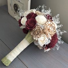 a bridal bouquet with white and red flowers