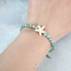 This cute starfish Amazonite stone bead bracelet features 4.2 mm faceted natural Mozambique Amazonite bead on stainless steel soft wire to maintain the round shape of the bracelet, a starfish bead added to the bracelet as an accent. The bracelet comes with a 5 cm adjustable stainless steel chain. Bracelet length: 18 cm + 5 cm adjustable chain Bead diameter: 4.2 mm Materials: Amazonite, stainless steel Jewelry Care: See more information about how to care for your jewelry here. Shipping Policy: Orders will be shipped within 1-3 business days. Economy shipping will take 7-14 days to arrive and standard shipping is 1- 4 days for U.S. orders. International shipping time is depended on the country and per shipping method. Shipping cost will be calculated at check out.For more details, see our Sh Adjustable Star Crystal Bracelet For Gifts, Adjustable Star Crystal Bracelet As Gift, Adjustable Star Crystal Bracelet Gift, Adjustable Star-shaped Crystal Bracelet Gift, Star-shaped Adjustable Crystal Bracelet, Adjustable Starfish Charm Bracelet Gift, Adjustable Beaded Bracelet With Starfish Charm As Gift, Cute Starfish, Amazonite Stone