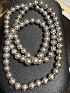 Beautiful vintage gray/silver simulated pearl necklace.   Necklace Length:  30 inches Classic Silver Pearl Necklace For Party, Gray Pearl Necklace For Formal Occasions, Gray Round Necklace For Formal Occasions, Elegant Gray Necklace For Evening, Formal Gray Pearl Necklace, Vintage Silver Long Pearl Necklace, Elegant Long Gray Necklace, Gray Pearl Necklace, Agate Stone Necklace