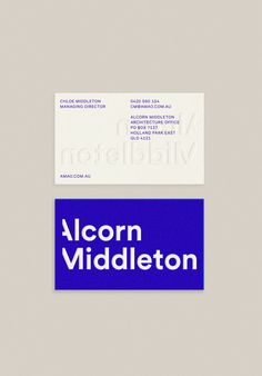 a close up of a business card on a white surface with blue and black text