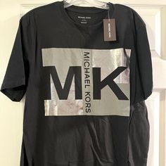 Nwt, Unisex Michael Kors T-Shirt, Black/Silver Metallic, Sz. L Silver Casual T-shirt With Letter Print, Casual Silver T-shirt With Letter Print, Silver Crew Neck T-shirt With Letter Print, Michael Kors Black Crew Neck Top, Silver Short Sleeve Graphic Tee, Silver Graphic Tee With Crew Neck, Silver Graphic Tee With Short Sleeves, Silver Graphic Print Cotton Top, Silver Crew Neck Cotton T-shirt