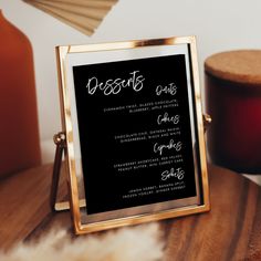 a menu on a wooden table next to candles