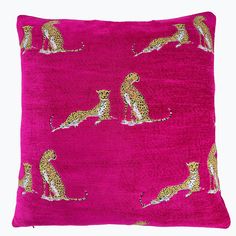 a pink pillow with gold leopards on it