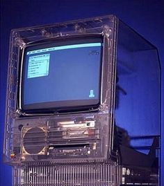 an old computer sitting on top of a plastic case with a screen in it's center