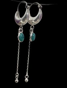 **Adorn your ears with the vibrant elegance of our sterling silver hoop earrings, featuring a charming turquoise gemstone as the centerpiece. The hoops are expertly crafted from high-quality sterling silver, offering a timeless look that complements any style. The turquoise gemstone adds a pop of color and a touch of bohemian flair, making these earrings the perfect accessory for any occasion. Whether you're dressing up for a night out or adding a chic accent to your everyday ensemble, these earrings are sure to turn heads and elevate your look. Turquoise Sterling Silver Hoop Earrings For Pierced Ears, Turquoise Dangle Hoop Earrings, Turquoise Small Hoop Sterling Silver Earrings, Turquoise Sterling Silver Hoop Earrings, Turquoise Small Hoop Earrings In Sterling Silver, Sterling Silver Turquoise Hoop Earrings, Turquoise Hoops, Chunky Hoop Earrings, Chunky Earrings