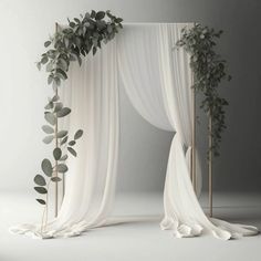 a white drape with greenery on it