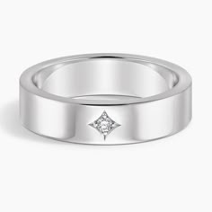 a white gold wedding ring with a diamond