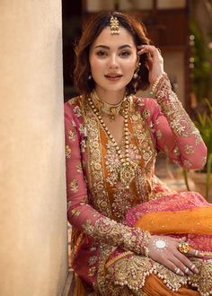 a woman sitting on the ground wearing a bridal outfit