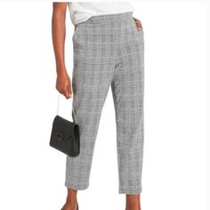 Perfect Pants For Work Paired With A Blazer And Flats Or Go Casual With A T-Shirt And Sneakers. Plaid Houndstooth Pattern In Black And White. Flat Front Elastic Waistband, Pull On Style. Side Slash Pockets Still Tacked Closed. Two Faux Welt Pockets On The Back. 82% Polyester 16% Rayon/Viscose 2% Elastane Approximate Measurements Laying Flat 16 1/2 Inches Across The Elastic Waist 11 Inch Rise 27 1/2 Inch Inseam Casual Houndstooth Bottoms For Business Casual, Casual Houndstooth Bottoms For Work, Casual Houndstooth Bottoms For Business, Casual Houndstooth Pattern Bottoms For Business, Casual Houndstooth Pants For Workwear, Casual Houndstooth Workwear Bottoms, Casual Houndstooth Pattern Pants For Workwear, Casual Houndstooth Ankle-length Pants, Pants For Work