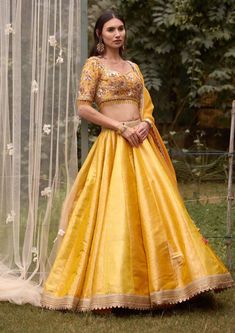 Editor's Note Featuring a zardozi embroidered lehenga on multi-coloured brocade base with belt and embroidered organza dupatta Color: Mustard Fabric: Brocade Sleeve: Half Neckline: Sweetheart Embroidery details: Zardozi Component: Blouse, Llehenga, belt and dupatta Lehenga length: 43" inches and blouse: 14" inches Occasion: Haldi, mehndi, sangeet and bridesmaid Care: Dry clean only About the Designer Shyam Narayan Prasad started his journey in the Indian Fashion Design Industry with a couture wo Brocade Lehenga, Mustard Fabric, Embroidered Lehenga, Embroidered Organza, Casual Tunics, Organza Dupatta, Indian Fashion Designers, Indian Ethnic Wear, Indian Designer Wear