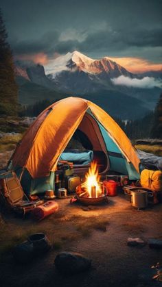 a tent is set up in the middle of a field with camping equipment around it