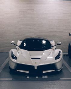 a white sports car parked in a parking lot