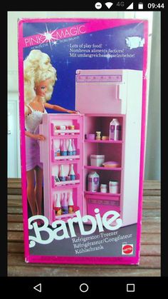 the barbie doll is standing next to an open refrigerator