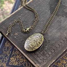 Oval vintage style locket. It is antiqued brass and the inside is quite a bit darker. On 28 inches of antiqued brass chain. Oval Locket Necklace, Mechanical Pocket Watch, Oval Locket, Sagittarius And Capricorn, Cameo Ring, Taurus And Gemini, Snowflake Obsidian, Locket Necklace, Brass Chain