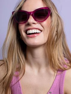 Introducing Amy Magenta – a classic and ultra-chic pair of modern-retro cat-eye sunglasses, redefining timeless style in a bold, wearable color for a classic edge to every outfit. Crafted from dark pink crystal magenta eco-acetate, Amy embodies both fun and elegance, universally flattering with playful charm. The smoke-to-pink lenses enchant, transitioning from dark blue-grey to soft pink, adding mystery and feminine allure. Handmade with precision, these frames are a lifelong investment, reglazable for personalized wear. Designed for small to medium-sized faces, Amy is versatile, complementing special occasions or everyday looks. Embrace the bold and beautiful fusion of classic charm with contemporary style. Pink Lenses, Dark Blue Grey, Purple Cat, Retro Cats, Cat Eyes, Eye Shapes, Modern Retro, Pink Crystal, Dark Pink