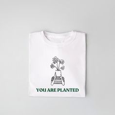 This soft tee gives a calming and grounded feeling, perfect for everyday wear or lounging at home. It is suitable for both men and women, offering a comfortable fit. Ideal for nature lovers, gardeners, or those who appreciate a peaceful vibe. Great for Earth Day, Arbor Day, or as a gift for plant enthusiasts. Product features - Made with 100% lightweight cotton for breathability - Retail fit suitable for casual or semi-formal settings - Shoulder tape provides extra stability - Ribbed knit collar Arbor Day, Arbour Day, Christmas Deals, Graphic Shirt, Garden Gifts, Knit Collar, Earth Day, Plant Lover, Nature Lovers