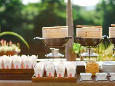 a buffet table with plates and cups on it