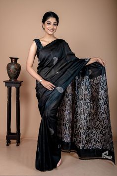 It's a minimalistic-looking silk block print. There are two types of Kalka block printing present in the saree. The anchal has abstract and contemporary Kalka motifs. Also, the body has a very traditional Kalka motif. This black silk saree has almost become synonymous with your perfect evening wear. This mulberry silk is intricately designed in a combination with traditional and abstract paisley block prints. Like all of our sarees, this saree is also silk mark certified. Hence, you don't have to worry about the quality of this black silk saree. Also, when you shop with us, you always get the best quality products. Be a black beauty This black color saree makes you look slimmer and instantly boosts your confidence. So, in a country like India, where bright and vibrant colors get all the at Luxury Black Slub Silk Traditional Wear, Luxury Black Raw Silk Saree, Luxury Black Slub Silk Saree, Luxury Black Tissue Silk Saree, Luxury Black Art Silk Pre-draped Saree, Luxury Black Handloom Saree, Luxury Black Katan Silk Pre-draped Saree, Luxury Black Saree With Printed Border, Luxury Black Tussar Silk Pre-draped Saree