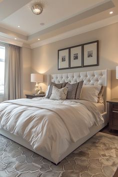 a large white bed sitting in a bedroom next to two lamps on either side of the bed