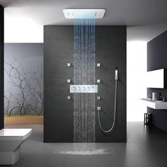 a shower head with water running down it's side in a modern style bathroom